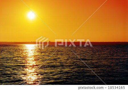 orange sunset over dark river 18534165
