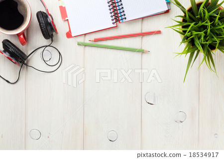 Desk with notepad, coffee and headphones Desk with notepad, coffee and headphones 18534917