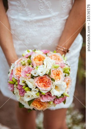 Beautiful wedding a bouquet in hands of the bride Beautiful wedding a bouquet in hands of the bride 18536576