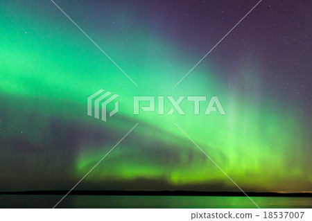 Northern lights over lake in finland 18537007