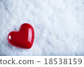 Red glossy heart on a frosty white snow background 18538159
