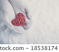 Female hands in white knitted mittens with a 18538174