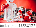Cute couple of little snowmen is standing near the 18538177