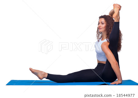 Studio shot of a young fit woman doing yoga 18544977