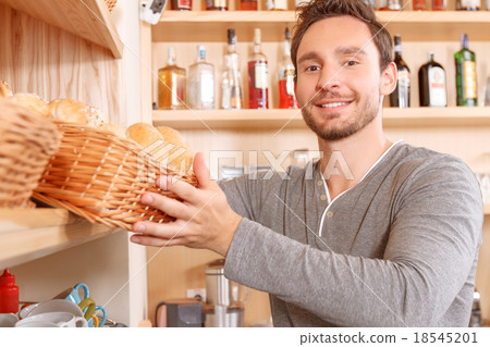 Man setting out goods on stalls Man setting out goods on stalls 18545201