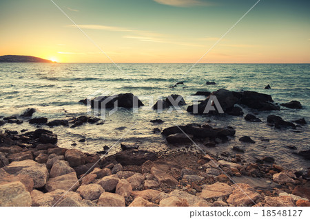 Coastal stones and sea water at sunset 18548127