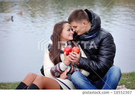 couple on a background of water in autumn with apples 18552307