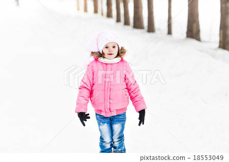 Happy baby girl in a winter park Happy baby girl in a winter park 18553049