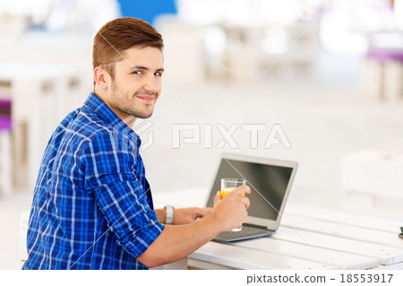 Positive freelancer working on the notebook Positive freelancer working on the notebook 18553917