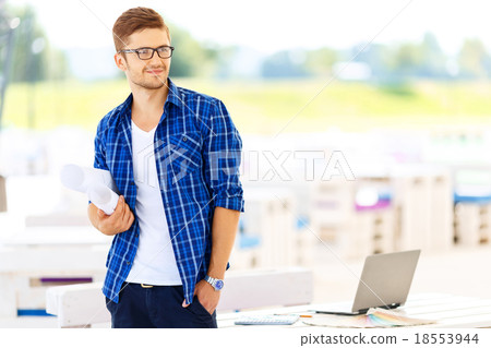 Professional guy standing near table Professional guy standing near table 18553944