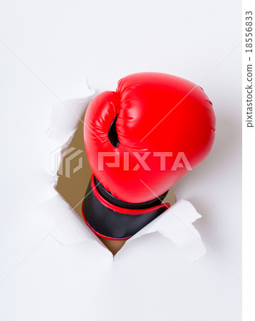 Boxing glove through a hole in paper Boxing glove through a hole in paper 18556833