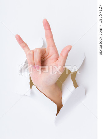 Peace sign gesture break through the paper wall 18557127