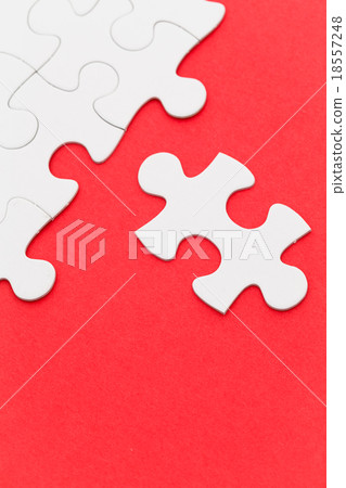 Incomplete white puzzle with red color background Incomplete white puzzle with red color background 18557248