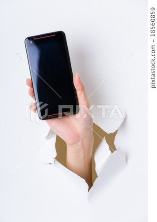 Hand break through paper and hold with blank screen of cellphone Hand break through paper and hold with blank screen of cellphone 18560859