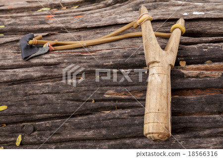 Slingshot on old wood table. Slingshot on old wood table. 18566316