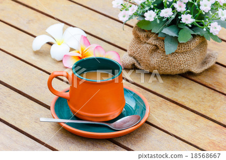 Hot coffee and notebook and flowers. 18568667