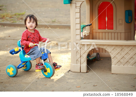 Infant riding a tricycle Infant riding a tricycle 18568849