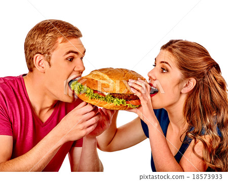 Man and woman eating big sandwich. Isolated. 18573933