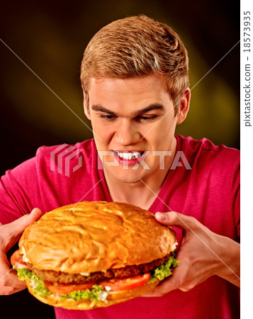Man eating big sandwich. 18573935
