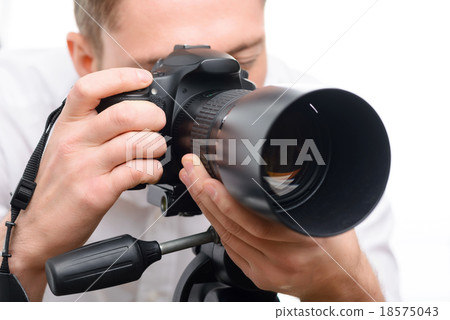 Handsome photographer filming with professional 18575043