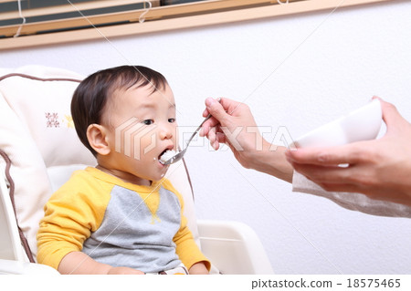 Babies and mothers eating baby food Babies and mothers eating baby food 18575465