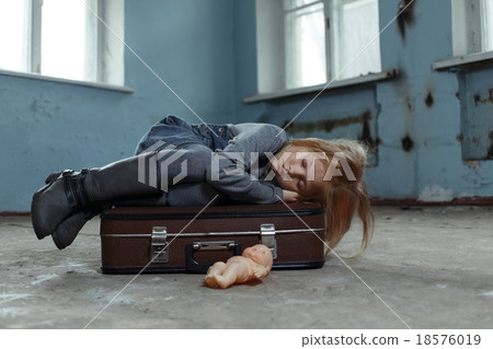 Lonely girl sitting on the suitcase  18576019