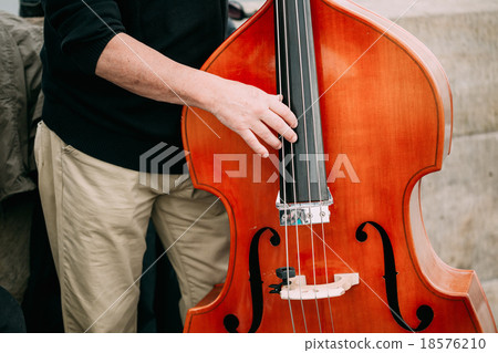 Street Busker performing jazz songs outdoors 18576210