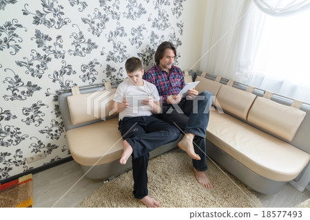 dad and son with tablet computer indoor dad and son with tablet computer indoor 18577493
