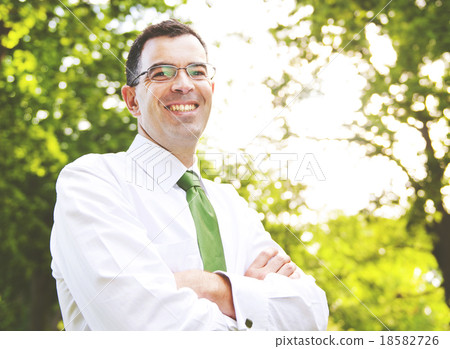 Businessman Arms Crossed In A Forest Concept 18582726