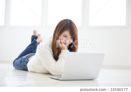 A woman using a computer A woman using a computer 18586577
