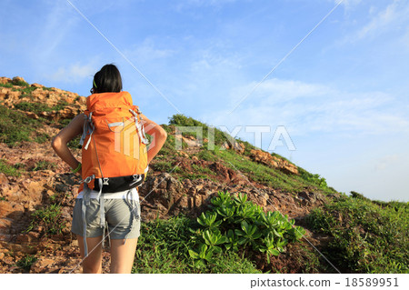 woman hiker climbing on seaside mountain woman hiker climbing on seaside mountain 18589951