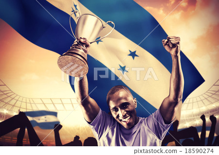 Composite image of portrait of happy sportsman cheering while ho 18590274