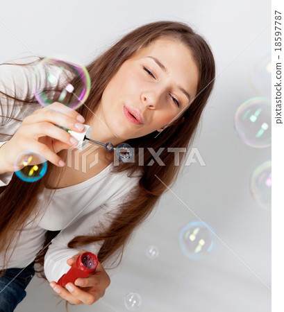 Girl making bubbles Girl making bubbles 18597787