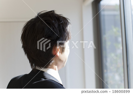 A businessman looking out A businessman looking out 18600899