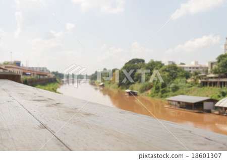 Empty wood table and river raft in background 18601307