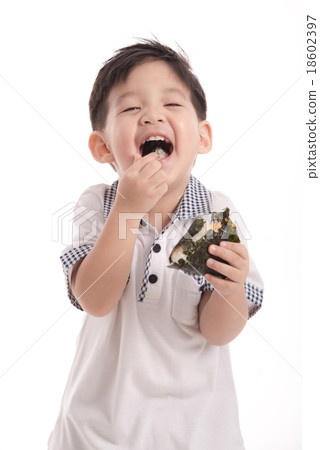 Cute asian child eating rice ball or onigiri Cute asian child eating rice ball or onigiri 18602397