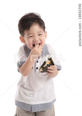 Cute asian child eating rice ball or onigiri Cute asian child eating rice ball or onigiri 18602398