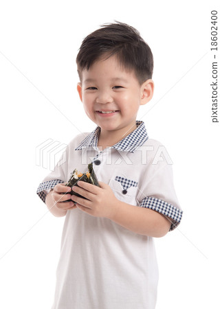 Cute asian child eating rice ball or onigiri Cute asian child eating rice ball or onigiri 18602400