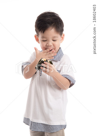 Cute asian child eating rice ball or onigiri 18602403