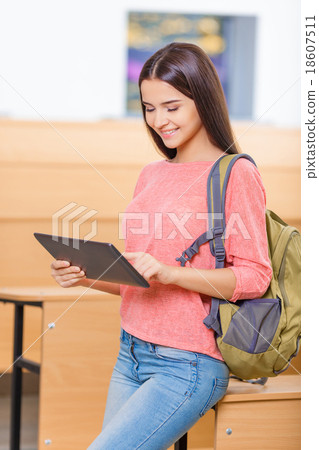 Stock Photo: Young excellent student girl working with tablet.