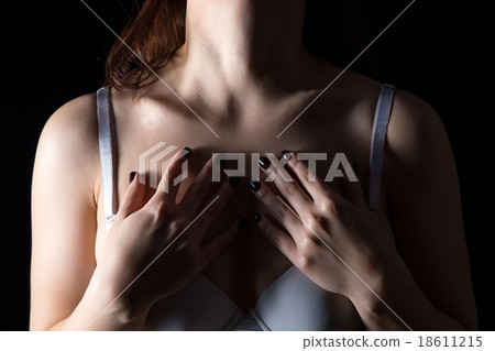 Woman with hands on chest Woman with hands on chest 18611215