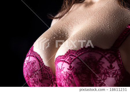 Woman's breast with drops in red bra 18611231