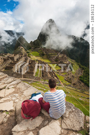 Tourist looking over Machu Picchu, Peru 18616112
