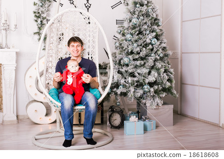 Dad and son at home with christmas tree Dad and son at home with christmas tree 18618608