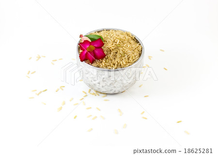 Uncooked brown rice on white background Uncooked brown rice on white background 18625281