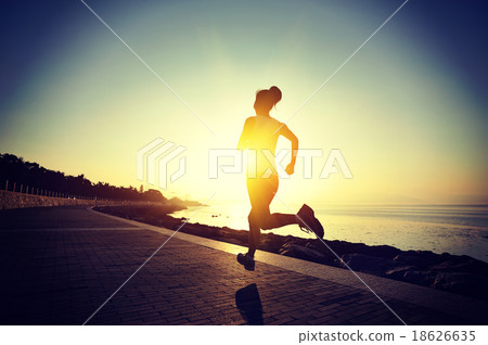 young fitness woman running on sunrise seaside   18626635