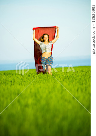 Young happy woman in wheat field with fabric Young happy woman in wheat field with fabric 18626992
