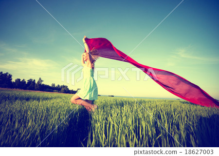 Young happy woman in wheat field with fabric 18627003