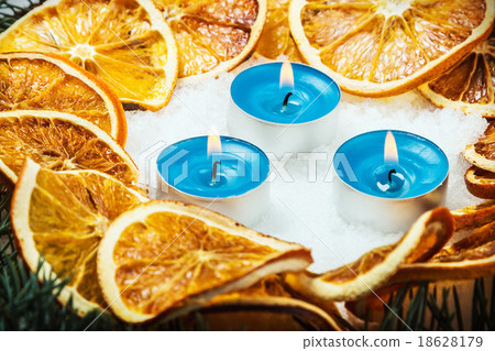 dried oranges and candles in the snow dried oranges and candles in the snow 18628179