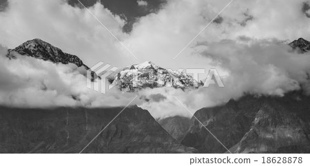 mountain peaks through the clouds mountain peaks through the clouds 18628878